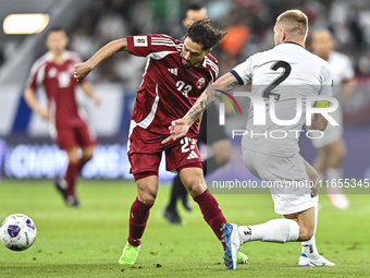 Abdelrahman Fahmi Moustafa (L) of Qatar battles for the ball with Kichin Valerii (R) of Kyrgyzstan during the FIFA World Cup 2026 AFC Asian...