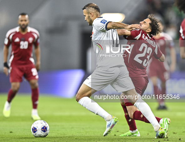 Abdelrahman Fahmi Moustafa of Qatar battles for the ball with Abdurakhmanov Odilzhon of Kyrgyzstan during the FIFA World Cup 2026 AFC Asian...