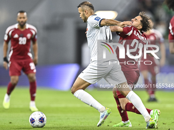 Abdelrahman Fahmi Moustafa of Qatar battles for the ball with Abdurakhmanov Odilzhon of Kyrgyzstan during the FIFA World Cup 2026 AFC Asian...