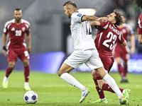 Abdelrahman Fahmi Moustafa of Qatar battles for the ball with Abdurakhmanov Odilzhon of Kyrgyzstan during the FIFA World Cup 2026 AFC Asian...