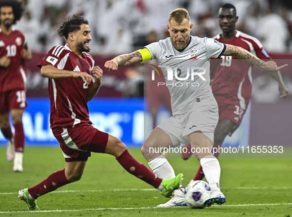 Abdelrahman Fahmi Moustafa of Qatar battles for the ball with Kichin Valerii of Kyrgyzstan during the FIFA World Cup 2026 AFC Asian Qualifie...