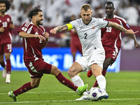 Abdelrahman Fahmi Moustafa of Qatar battles for the ball with Kichin Valerii of Kyrgyzstan during the FIFA World Cup 2026 AFC Asian Qualifie...