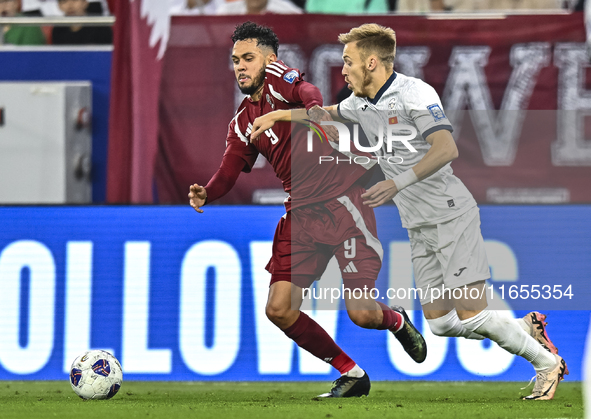 Edmilson Junior Dasilva (L) of Qatar battles for the ball with Aleksandr Mishchenko (R) of Kyrgyzstan during the FIFA World Cup 2026 AFC Asi...