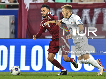 Edmilson Junior Dasilva (L) of Qatar battles for the ball with Aleksandr Mishchenko (R) of Kyrgyzstan during the FIFA World Cup 2026 AFC Asi...