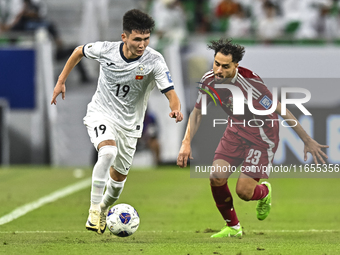 Abdelrahman Fahmi Moustafa of Qatar battles for the ball with Ermek Kenzhebaev of Kyrgyzstan during the FIFA World Cup 2026 AFC Asian Qualif...