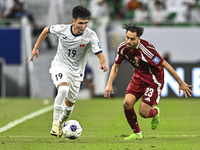 Abdelrahman Fahmi Moustafa of Qatar battles for the ball with Ermek Kenzhebaev of Kyrgyzstan during the FIFA World Cup 2026 AFC Asian Qualif...