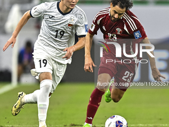 Abdelrahman Fahmi Moustafa of Qatar battles for the ball with Ermek Kenzhebaev of Kyrgyzstan during the FIFA World Cup 2026 AFC Asian Qualif...