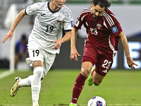 Abdelrahman Fahmi Moustafa of Qatar battles for the ball with Ermek Kenzhebaev of Kyrgyzstan during the FIFA World Cup 2026 AFC Asian Qualif...