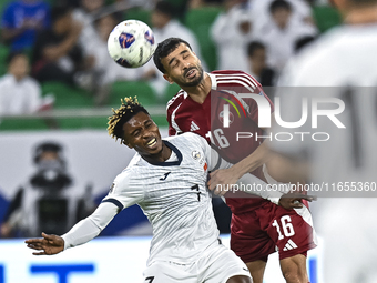 Boualem Khoukhi of Qatar battles for the ball with Joel Kojo of Kyrgyzstan during the FIFA World Cup 2026 AFC Asian Qualifiers 3rd round gro...