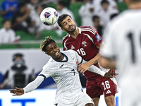 Boualem Khoukhi of Qatar battles for the ball with Joel Kojo of Kyrgyzstan during the FIFA World Cup 2026 AFC Asian Qualifiers 3rd round gro...