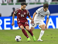 Abdelrahman Fahmi Moustafa of Qatar battles for the ball with Alimardo Shukurov of Kyrgyzstan during the FIFA World Cup 2026 AFC Asian Quali...