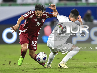 Abdelrahman Fahmi Moustafa of Qatar battles for the ball with Alimardo Shukurov of Kyrgyzstan during the FIFA World Cup 2026 AFC Asian Quali...