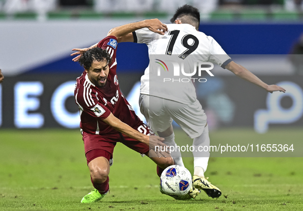 Abdelrahman Fahmi Moustafa of Qatar battles for the ball with Alimardo Shukurov of Kyrgyzstan during the FIFA World Cup 2026 AFC Asian Quali...