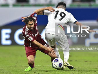 Abdelrahman Fahmi Moustafa of Qatar battles for the ball with Alimardo Shukurov of Kyrgyzstan during the FIFA World Cup 2026 AFC Asian Quali...