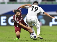 Abdelrahman Fahmi Moustafa of Qatar battles for the ball with Alimardo Shukurov of Kyrgyzstan during the FIFA World Cup 2026 AFC Asian Quali...