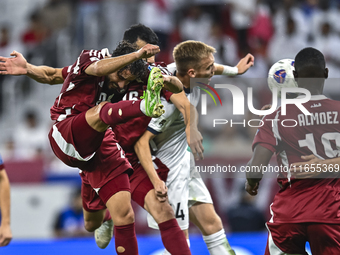 Almoez Ali (R) of Qatar battles for the ball with Aleksandr Mishchenko (C) of Kyrgyzstan during the FIFA World Cup 2026 AFC Asian Qualifiers...