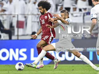 Akram Afif of Qatar battles for the ball with Abdurakhmanov Odilzhon of Kyrgyzstan during the FIFA World Cup 2026 AFC Asian Qualifiers 3rd r...