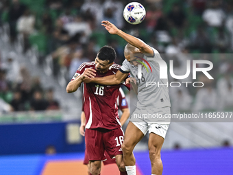 Boualem Khoukhi of Qatar battles for the ball with Kairat Zhyrgalbek Uulu of Kyrgyzstan during the FIFA World Cup 2026 AFC Asian Qualifiers...