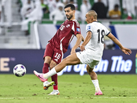 Boualem Khoukhi of Qatar battles for the ball with Kairat Zhyrgalbek Uulu of Kyrgyzstan during the FIFA World Cup 2026 AFC Asian Qualifiers...