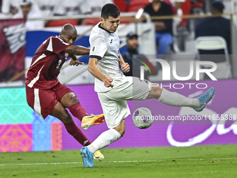 Abdelkarim Hassan of Qatar battles for the ball with Zarypbbekov Eldiiar of Kyrgyzstan during the FIFA World Cup 2026 AFC Asian Qualifiers 3...