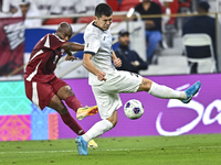 Abdelkarim Hassan of Qatar battles for the ball with Zarypbbekov Eldiiar of Kyrgyzstan during the FIFA World Cup 2026 AFC Asian Qualifiers 3...