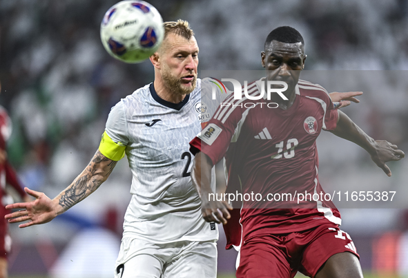 Almoez Ali (R) of Qatar battles for the ball with Kichin Valerii of Kyrgyzstan during the FIFA World Cup 2026 AFC Asian Qualifiers 3rd round...