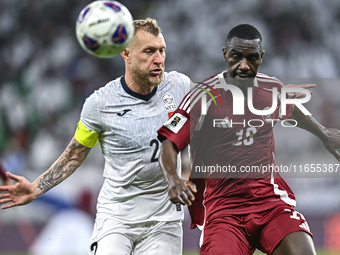 Almoez Ali (R) of Qatar battles for the ball with Kichin Valerii of Kyrgyzstan during the FIFA World Cup 2026 AFC Asian Qualifiers 3rd round...