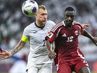 Almoez Ali (R) of Qatar battles for the ball with Kichin Valerii of Kyrgyzstan during the FIFA World Cup 2026 AFC Asian Qualifiers 3rd round...