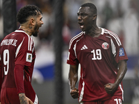 Almoez Ali (R) of Qatar celebrates with Edmilson Junior Dasilva after scoring the opening goal during the FIFA World Cup 2026 AFC Asian Qual...