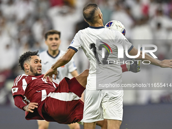 Edmilson Junior Dasilva of Qatar battles for the ball with Abdurakhmanov Odilzhon of Kyrgyzstan during the FIFA World Cup 2026 AFC Asian Qua...