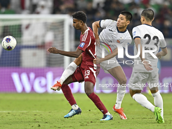 Ibrahim Mohammadali of Qatar battles for the ball with Tamirlan Kozubaev of Kyrgyzstan during the FIFA World Cup 2026 AFC Asian Qualifiers 3...