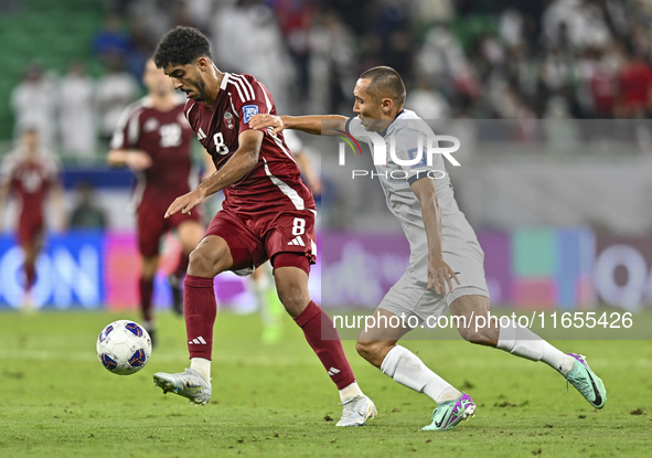 Jassem Gaber Abdulsallam of Qatar battles for the ball with Suiuntbek Mamyraliev of Kyrgyzstan during the FIFA World Cup 2026 AFC Asian Qual...