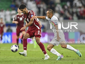 Jassem Gaber Abdulsallam of Qatar battles for the ball with Suiuntbek Mamyraliev of Kyrgyzstan during the FIFA World Cup 2026 AFC Asian Qual...