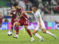 Jassem Gaber Abdulsallam of Qatar battles for the ball with Suiuntbek Mamyraliev of Kyrgyzstan during the FIFA World Cup 2026 AFC Asian Qual...