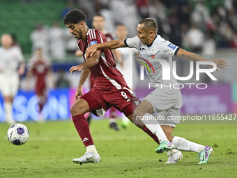 Jassem Gaber Abdulsallam of Qatar battles for the ball with Suiuntbek Mamyraliev of Kyrgyzstan during the FIFA World Cup 2026 AFC Asian Qual...