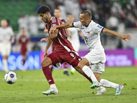 Jassem Gaber Abdulsallam of Qatar battles for the ball with Suiuntbek Mamyraliev of Kyrgyzstan during the FIFA World Cup 2026 AFC Asian Qual...