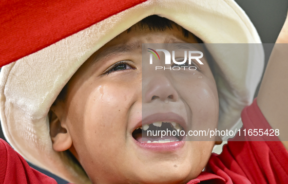 A young fan from Kyrgyzstan reacts after the team's loss in the FIFA World Cup 2026 AFC Asian Qualifiers 3rd round group A match between Qat...