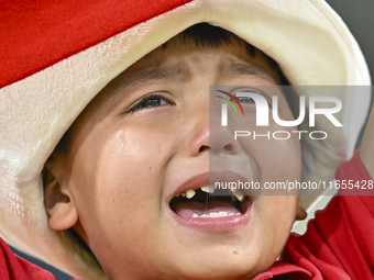 A young fan from Kyrgyzstan reacts after the team's loss in the FIFA World Cup 2026 AFC Asian Qualifiers 3rd round group A match between Qat...