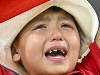 A young fan from Kyrgyzstan reacts after the team's loss in the FIFA World Cup 2026 AFC Asian Qualifiers 3rd round group A match between Qat...