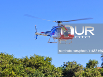 A Heli General Aviation AC311 helicopter performs a sightseeing flight in Yantai, China, on October 1, 2023. The Civil Aviation Administrati...