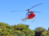 A Heli General Aviation AC311 helicopter performs a sightseeing flight in Yantai, China, on October 1, 2023. The Civil Aviation Administrati...