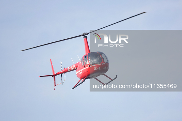 A Tianjin Jinjintong R44 helicopter performs a sightseeing flight in Binhai New Area, Tianjin, China, on October 4, 2023. The Civil Aviation...