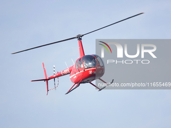 A Tianjin Jinjintong R44 helicopter performs a sightseeing flight in Binhai New Area, Tianjin, China, on October 4, 2023. The Civil Aviation...