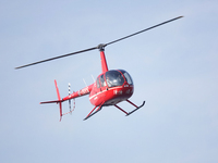 A Tianjin Jinjintong R44 helicopter performs a sightseeing flight in Binhai New Area, Tianjin, China, on October 4, 2023. The Civil Aviation...