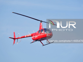 A Tianjin Jinjintong R44 helicopter performs a sightseeing flight in Binhai New Area, Tianjin, China, on October 4, 2023. The Civil Aviation...