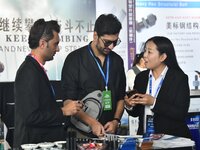 An exhibitor introduces fastener product information to foreign merchants at the 2024 International Procurement Conference in Handan, China,...