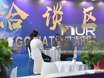 Foreign merchants negotiate business at the 2024 International Procurement Conference in Handan, China, on October 10, 2024. (