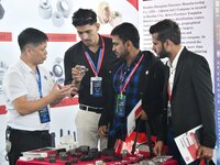 An exhibitor introduces fastener product information to foreign merchants at the 2024 International Procurement Conference in Handan, China,...