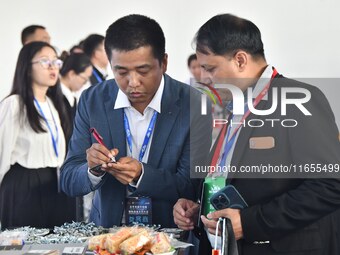 Foreign merchants learn about fastener products at the 2024 International Procurement Conference in Handan, China, on October 10, 2024. (