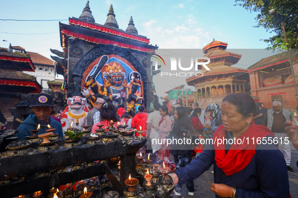 A Nepali Hindu devotee offers prayers to Kaal Bhairav in Kathmandu Durbar Square in Kathmandu, Nepal, on October 11, 2024, on the final day...